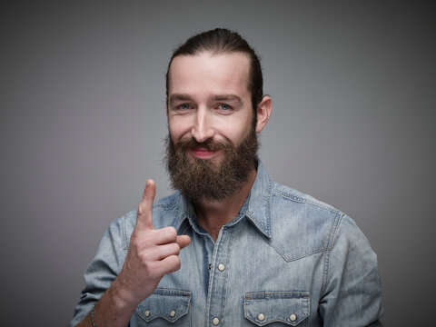 Portrait of man with outstretched index finger