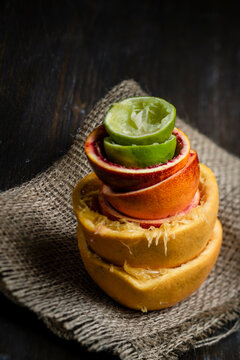 Stack of pressed citrus fruit on jute sack, close up