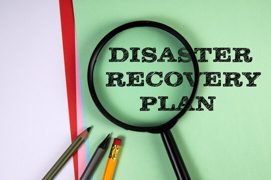 DISASTER RECOVERY PLAN Examined Through Magnifying Glass on Office Papers