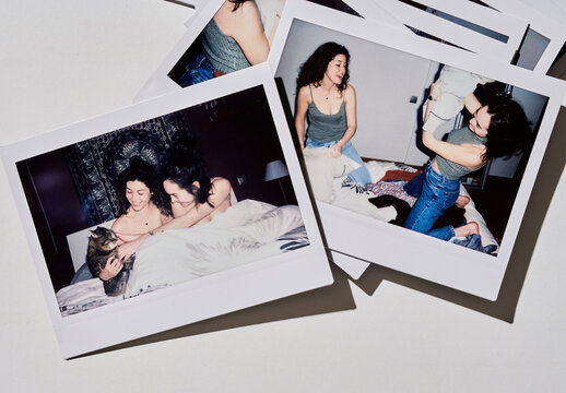 Mockup of polaroid frames lie on a flat surface. The frames are all empty and ready for images.