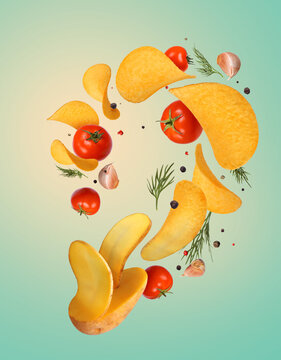 Potato chips floating in the air with dill and tomatoes on a blue background