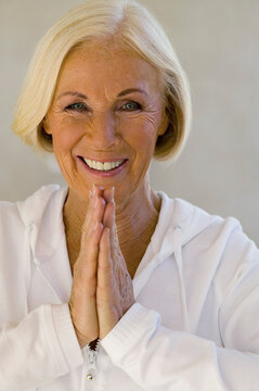 Senior woman meditating, smiling, close-up, portrait