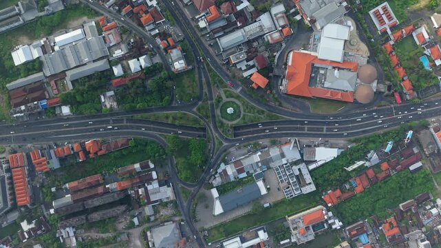 Aerial view of Statue of Dewa Ruci roundabout with surrounding traffic and urban infrastructure in Kecamatan Kuta, Bali, Indonesia.