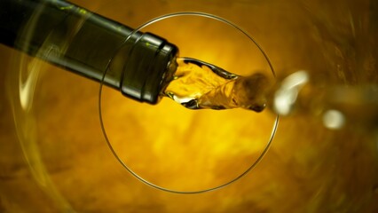 Naklejka premium White Wine Pouring Into Glass From Below