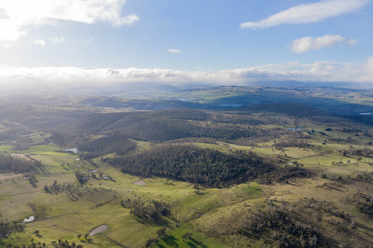 rolling green farmlands, country roads, and dams in a scenic Australian valley summer