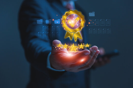 A businessman cradles a glowing five-star rating and a gold quality assurance seal in his open hand. Five golden stars shine brilliantly to show perfect reviews and top-rated product benchmarks.