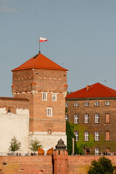 Vertical architectural photo of Wawel castle tower with Polish flag real life photography