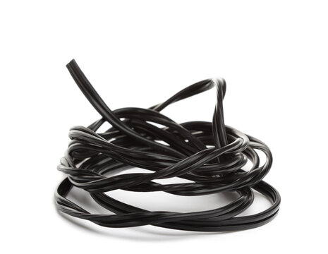 Coiled black cable tangled in a loose knot, isolated, minimal composition, connection and disorder concept