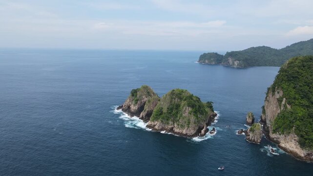 Aerial drone view of scenic tropical rocky islands in blue ocean