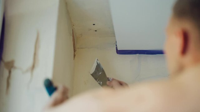 Close up of handyman plastering top corner of the room, home improvement and DIY repair