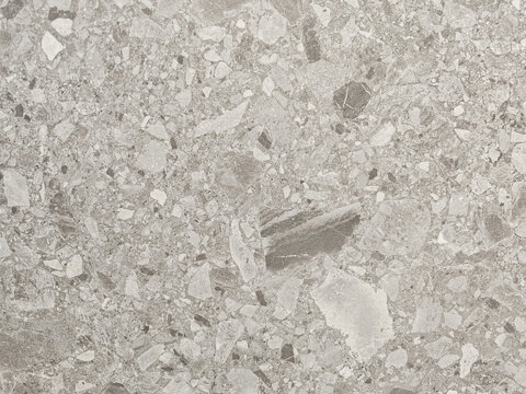Seamless neutral gray terrazzo stone composite texture backdrop featuring natural marble aggregate chips for interior architecture modern surface design and graphic backgrounds