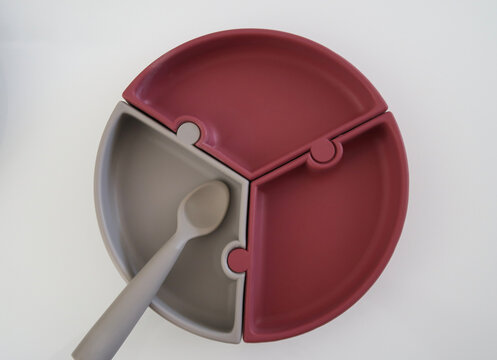 Silicone baby divided plates with spoon on white background