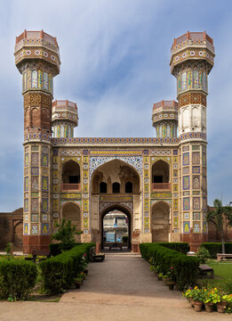 View of the historic Chauburji monument featuring intricate tile work and four minarets set within a garden in Lahore, Punjab, Pakistan.