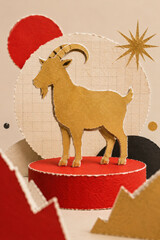 Fototapeta premium Layered paper collage of a goat in red and gold marking the Chinese year of the goat 2027