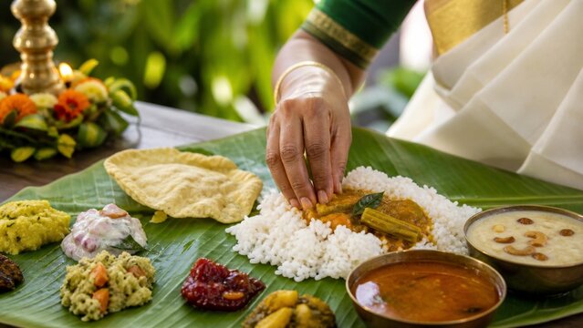 Hand serving rice at a traditional Onam sadhya feast