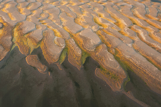 Aerial view of sand dunes and flowing Danube water during low river levels