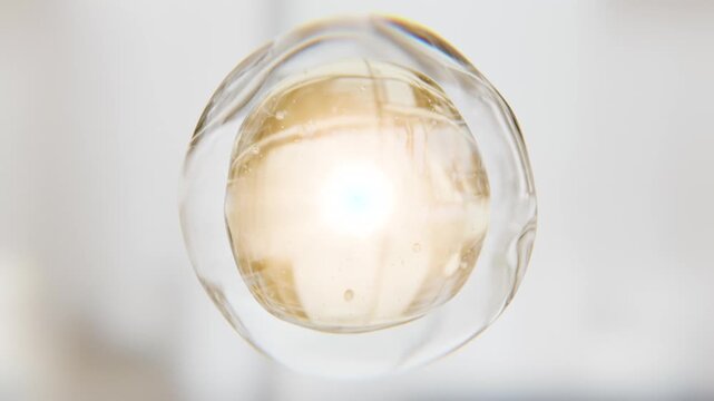 Luxury golden serum liquid bubble. Beauty cosmetics macro 3D abstract background. Bio moisturizer essence gel or oil drop. Collagen fluid molecule. Moisturizing peptide face cream. Skin lifting lotion