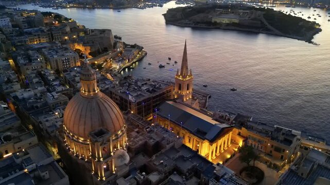 Aerial view of Basilica of Our Lady of Mount Carmel and Saint Pauls Anglican Pro Cathedral in Valletta Malta at twilight.