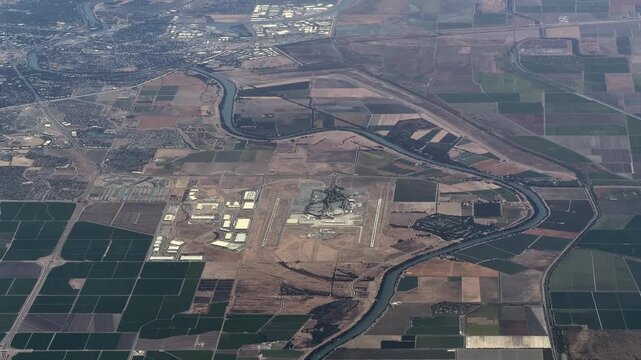 flying along Sacramento International Airport (IATA: SMF, ICAO: KSMF) with Runways, Taxiways, Tarmac, Terminal Buildings and Air Traffic Control Tower, next to river Sacramento River