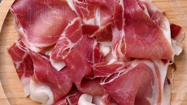 Serrano ham slices rotating. Top view