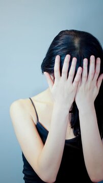 悩み、頭を抱える女性_縦長