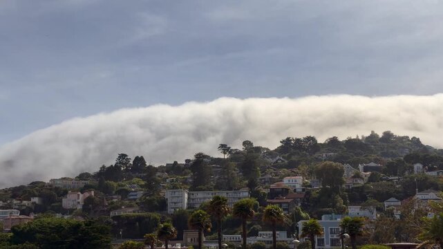 4k video footage of developed hillside in Sausalito, California with Clouds Flowing Over the Mountains, arriving from Pacific Ocean 