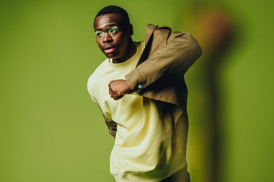 Bold urban fashion portrait of a man in a vibrant studio setting