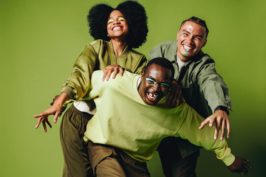 Friends bring movement and dance into a playful studio portrait