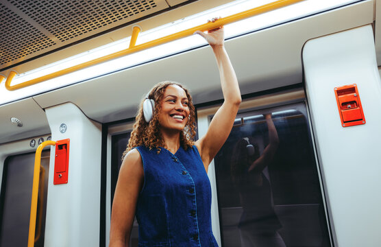 Woman riding subway holding handle during commute