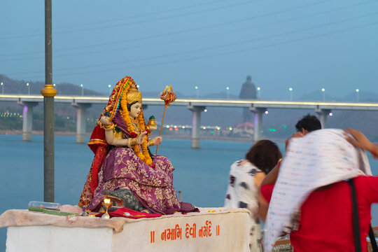 Ekta Nagar, India - 25 June 2026: Devotees gather for Narmada Aarti near the Statue of Unity, celebrating spiritual faith, pilgrimage, tourism and a scenic river cruise along the sacred river at dusk.