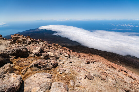 Santa Cruz de Tenerife, Canary Islands, Spain - 28 June 2026: View of the volcanic landscape from the summit of Mount Teide with a sea of clouds stretching towards the horizon.