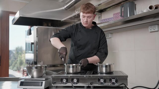 Young male pastry chef preparing cream