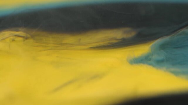 Shooting paint underwater with ink spreading in different colors