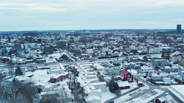 Aerial view of Vaxjo residential neighborhoods covered in winter snow, daytime cityscape
