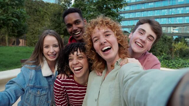 Happy multiethnic friends taking a selfie video together outdoors