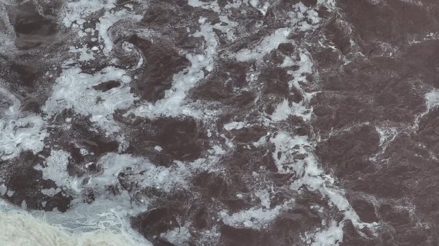 Closeup surface of swirling water and bio foam in biogas clarifier tank