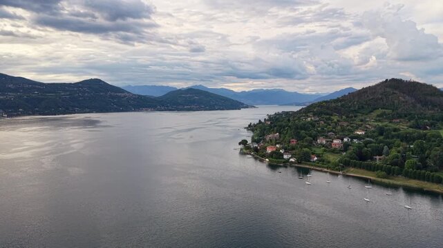 Aerial flying over Lake Maggiore at sunset. Arona, Italy
