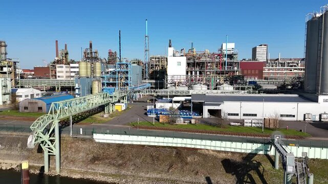 Drone makes a fast short orbit around a compact chemical process structure from a high industrial angle.
