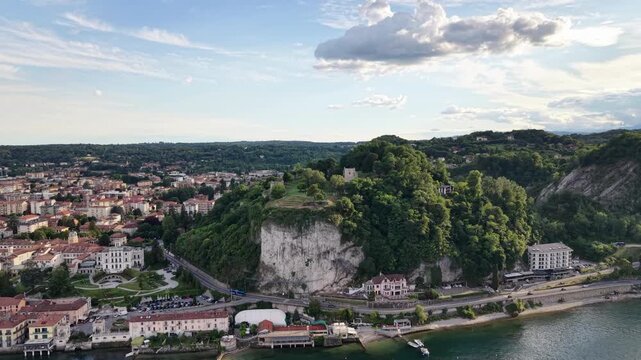 Rocca Borromeo di Arona Overlooks The Town Of Arona And The Southern Basin Of Lake Maggiore In Piedmont, Italy. Aerial Drone Shot