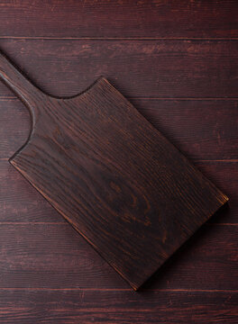 A square wooden cutting board for home food preparation. A wooden cutting board