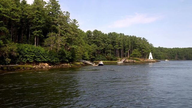 Riverbank of the Kennebec river showing boat and trees