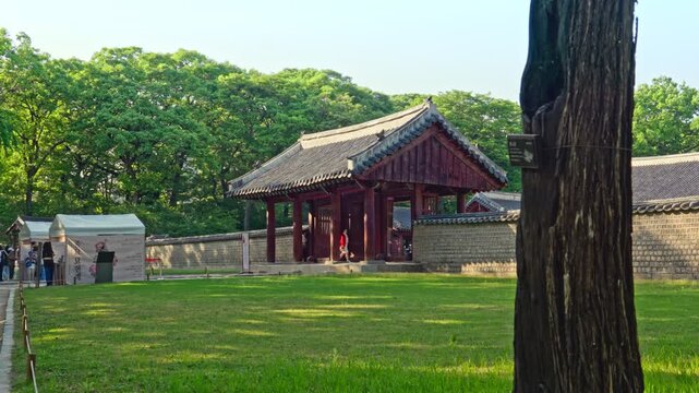 Changdeokgung Palace is a UNESCO World Heritage site featuring ornate Dancheong paintwork, curved tiled roofs, and Japsang figurines along the eaves of Donhwamun Gate under a bright sky.