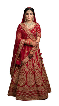 Traditional Indian bride in red lehenga and gold jewelry isolated