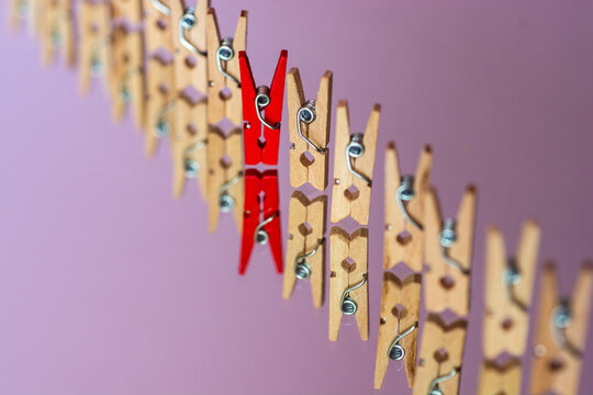 Color clothespin against of ordinary, abstract vision be different, unique personality, leader, standing out from the crowd. Motivation poster banner background.