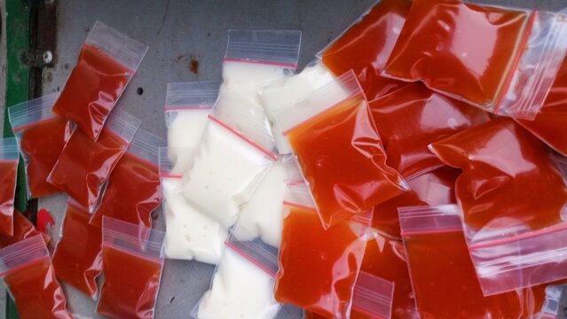 Small Ziplock Plastic Bags Filled with Red Chili Sauce and Mayonnaise Condiments