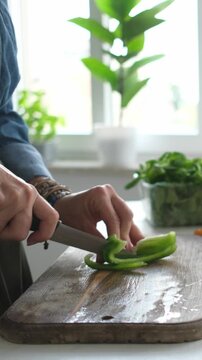 Woman Slicing Green Pepper For Salad. Vertical Video