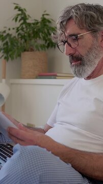Mature businessman working from home in pajamas