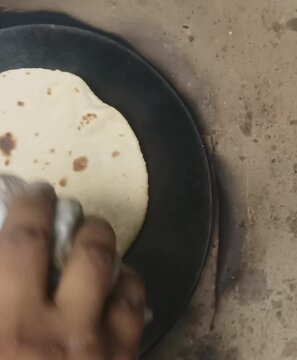 Cooking Roti on Traditional Iron Tawa in Village Kitchen