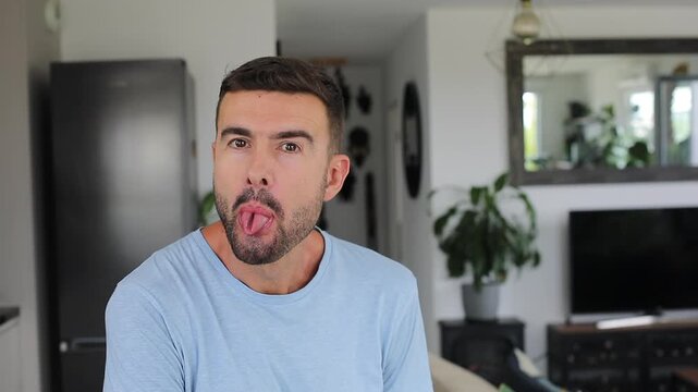 Man making a coned shape with his tongue at camera.