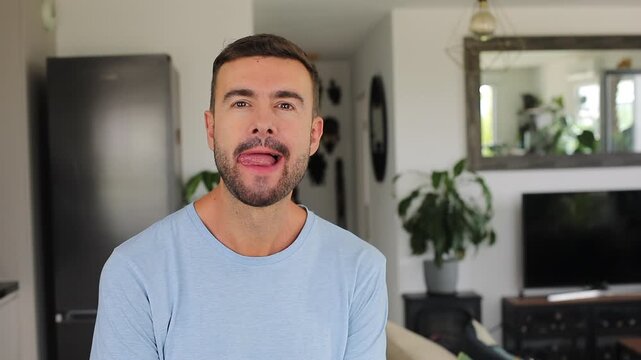 Man looking at the camera with desire and licking his lips in anticipation of a delicious meal